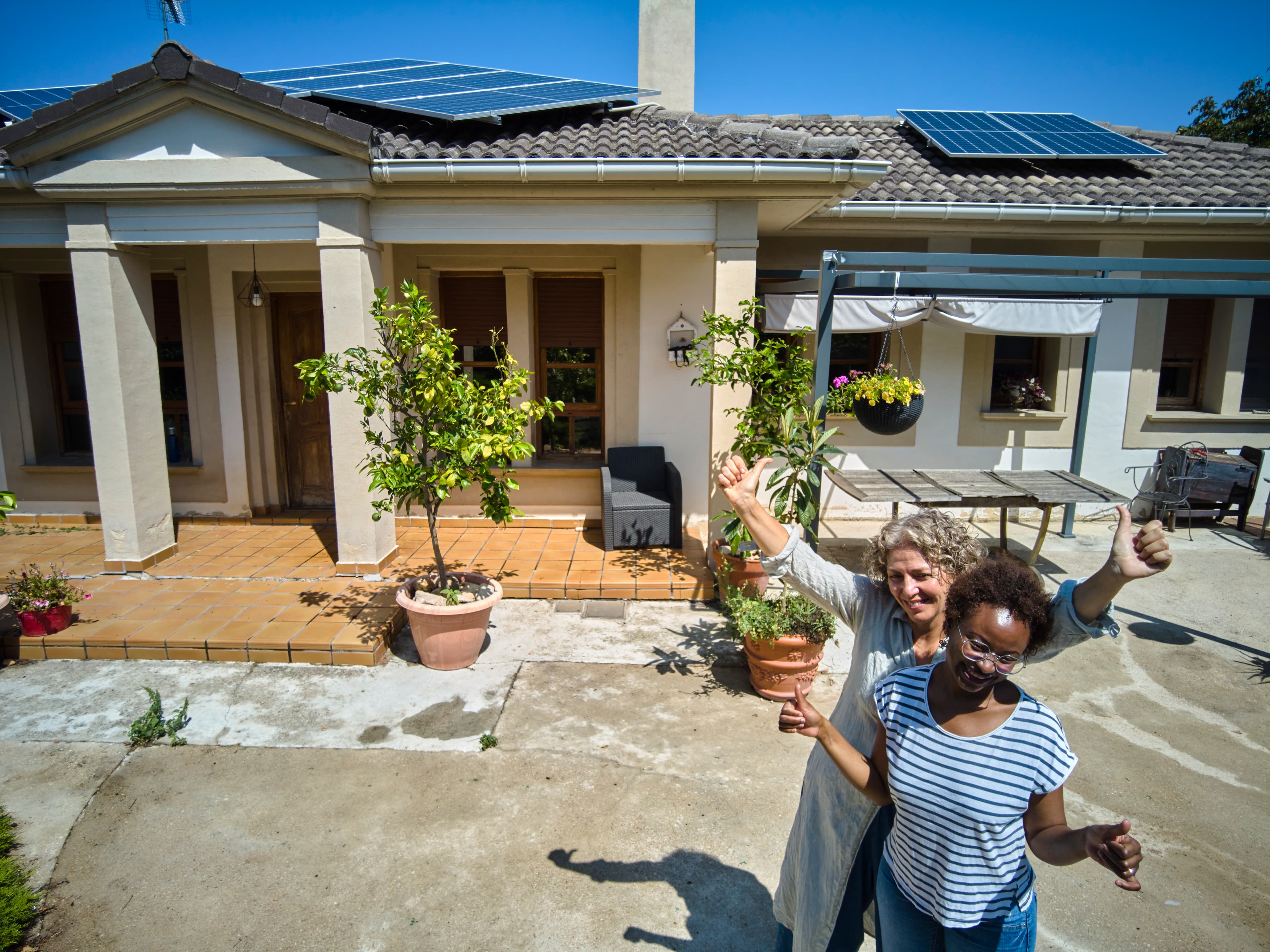 Eco-friendly subtropical Queensland home with solar panels and outdoor plants.