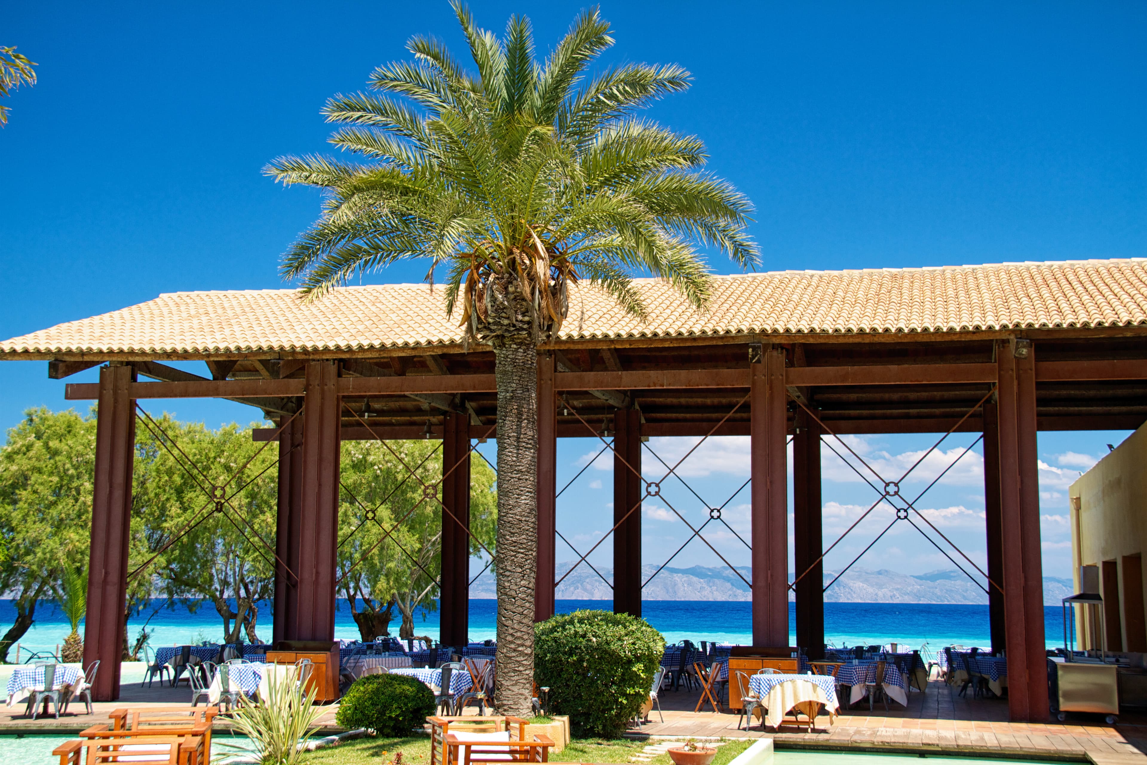 Pergola on the Gold Coast beach with dining setup.
