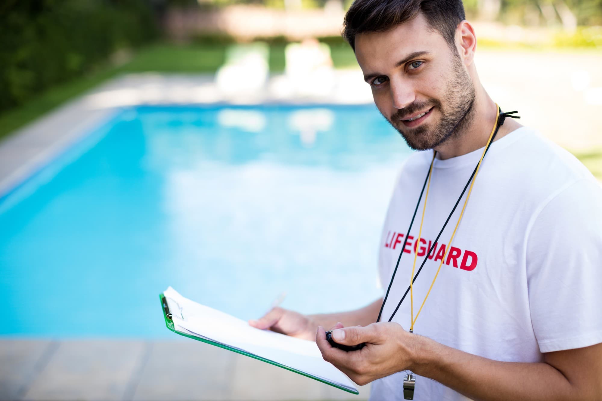 Lifeguard checking pool safety certificate at Queensland home.