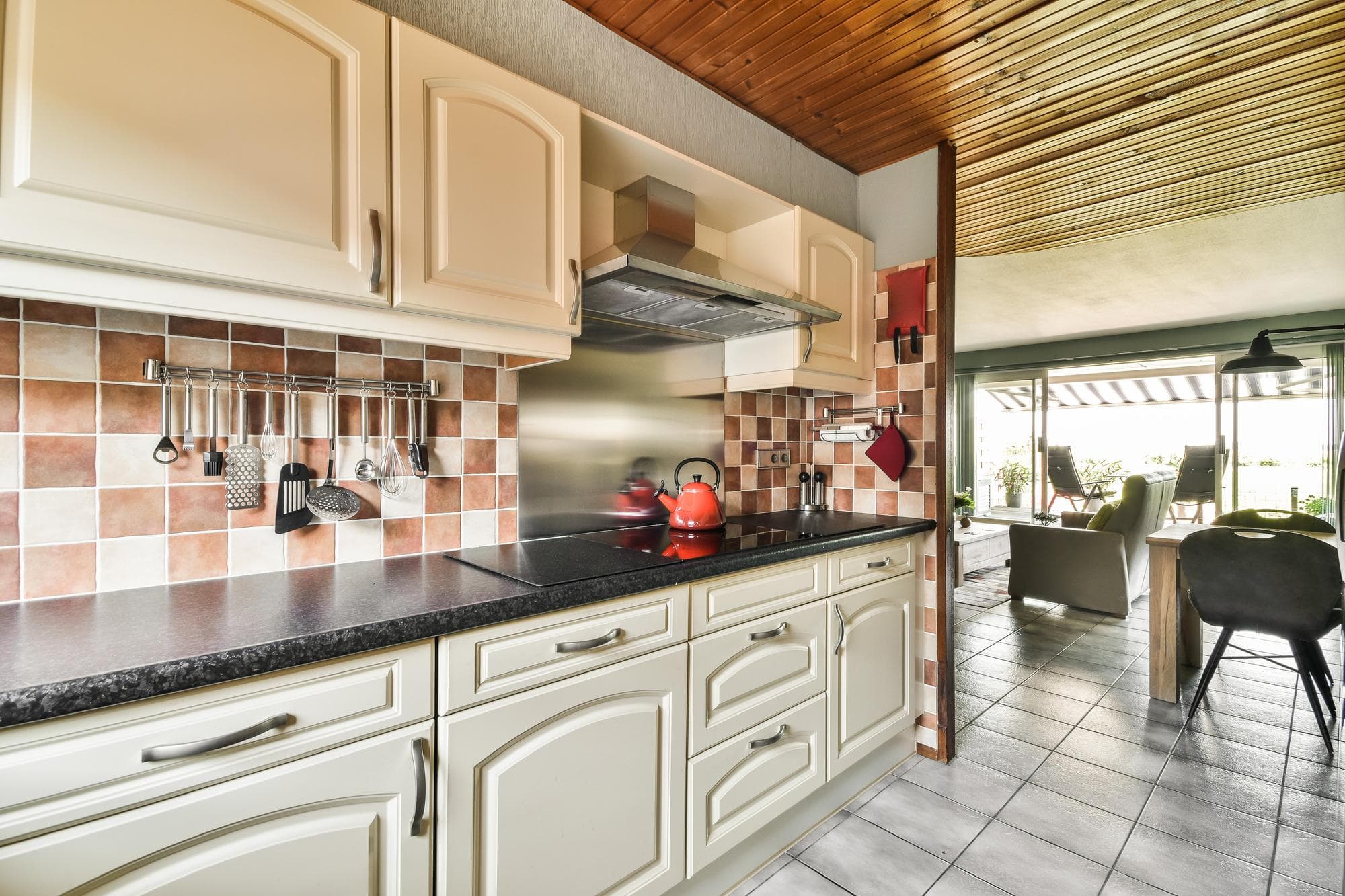 Modern Australian kitchen with tiled backsplash and wooden accents.